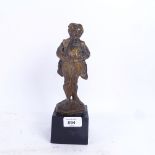 A modern resin sculpture of a man in a dress coat, indistinctly signed, overall height 25cm