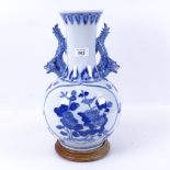 A blue and white Oriental porcelain vase on plinth, 37.5cm