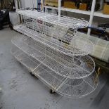 A large white wirework oval 4-tier display stand, L220cm, H120cm, D90cm