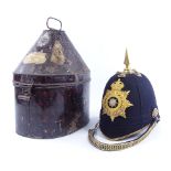 East Surrey Regiment military helmet with gilt-brass crest and brass-mounted chin strap, in tin case