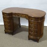 A walnut kidney-shaped pedestal desk, mid-20th century, with shaped moulded panelled drawer fronts