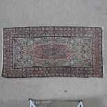 A pink ground Persian rug with intricate pattern, 154 x 82cm. Fading and wear consistent with age