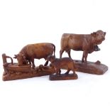 3 20th century Black Forest wood carvings, 2 bell cows and a St Bernard rescue dog, largest cow