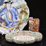 A Chinese oval porcelain dish with a panel of text in enamel floral surround, length 18cm, a