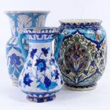 3 Iznik / Persian earthenware vases, tallest 18cm. All vases have chips and glaze loss at rim and