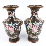A pair of 19th century porcelain vases and covers, with enamel decoration and gilded ram's head