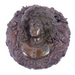 A late 19th century patinated bronze bust of a lady wearing a large bonnet, no visible signature, in