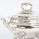 A large silver plated 2-handled soup tureen and cover, with cast foliate decoration on scrolled