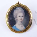 A Georgian miniature watercolour on ivory, head and shoulders portrait of a lady wearing a blue