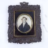 A Georgian miniature watercolour on ivory, half-length portrait of a gentleman wearing a black