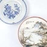A Chinese porcelain plate with painted mountain scene, diameter 24cm, and a blue and white porcelain