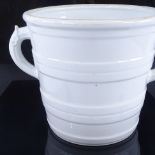 A 19th century white glaze ceramic 2-handled milk pail with raised bands, diameter excluding handles