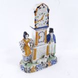 A rare Yorkshire Pratt Ware longcase clock group moneybox, flanked by a pair of figures and a dog in