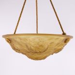 A French moulded amber glass hanging light bowl, with relief spring flower design, original gilded