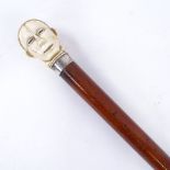 A 19th century malacca walking cane, with stylised carved ivory head knop, 82cm. Good condition,
