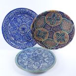 3 Middle Eastern majolica dishes, two signed on base, largest diameter 29cm. The 2 largest dishes