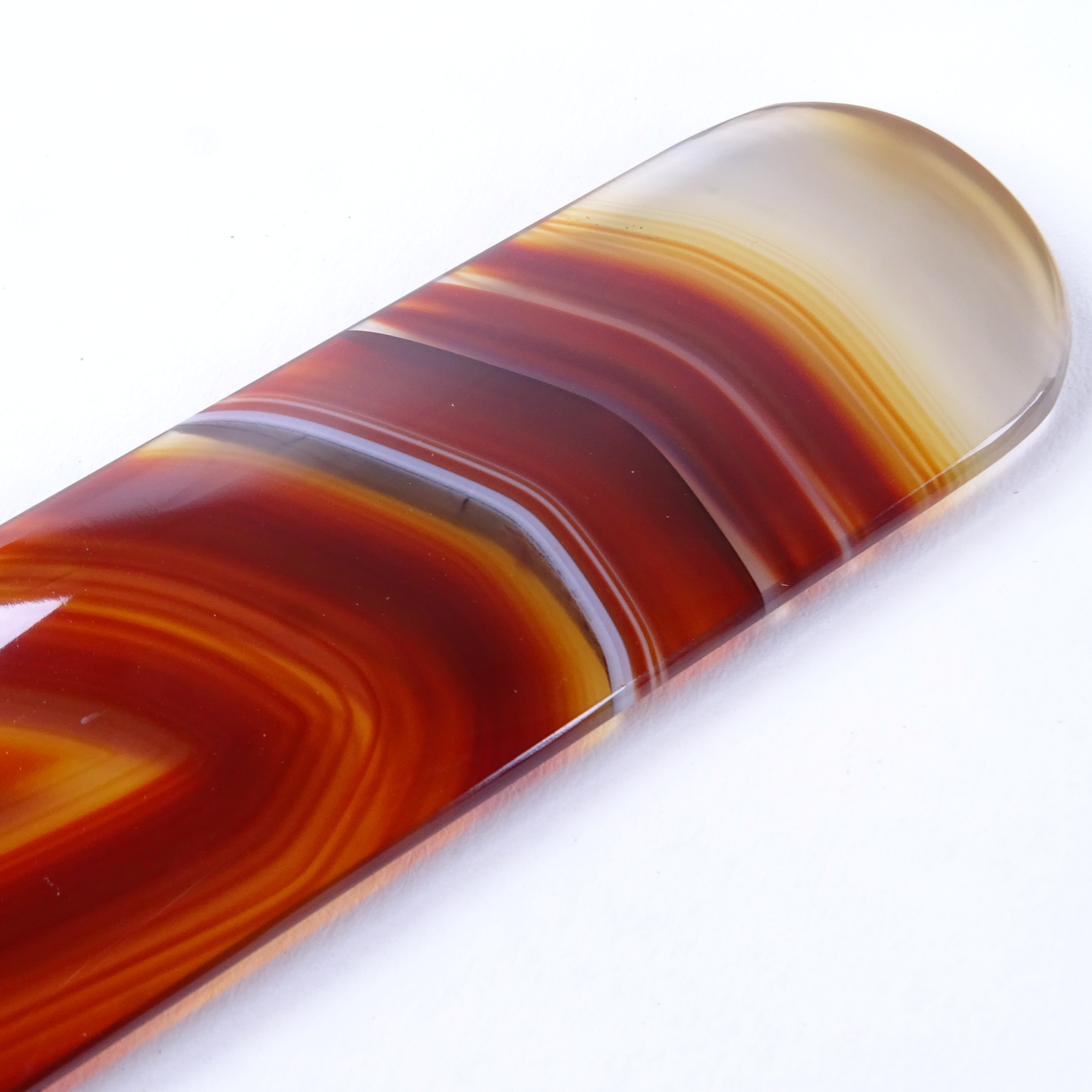 A polished red banded agate page turner, length 21cm Good condition. - Image 2 of 3