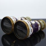 A pair of French enamelled opera glasses, hand painted floral decoration on blue and gilt ground,