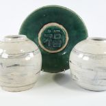 A Chinese green glaze pottery bowl with central text panel, diameter 24cm, and a pair of blue and