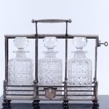 A Victorian electroplate 3 bottle tantalus, by Olliant & Botsford circa 1880, length 34cm. Frame