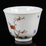 A Chinese porcelain tea bowl, with painted blossom tree and text, 6 character mark, diameter 6.
