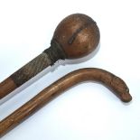A hardwood Tribal club with metal wirework-bound handle, length 80cm, and a walking stick with