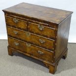 An 18th century figured walnut bachelor's chest of drawers, with brushing slide, ornate multi-