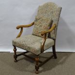 A Victorian beech-framed Carolean style armchair