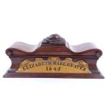 A mid-19th century mahogany sarcophagus-shaped pen box, with shaped and scrolled hinged lid and