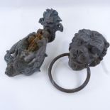 A cast bronze door knocker, in Bacchanalian design, length 29cm, and a bronze lion mask door knocker