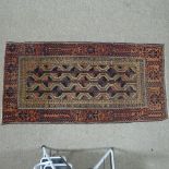 An antique red and brown ground Tekke design wool rug 192 x 97cm Some areas of wear especially at