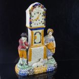 A rare Yorkshire Pratt Ware longcase clock group moneybox, flanked by a pair of figures and a dog in