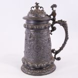 A large Victorian pewter presentation lidded tankard, with relief decorated figures and inscription,