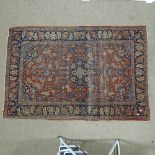 An intricate antique red ground Persian rug, 200 x 135cm. A number of areas of wear and fading