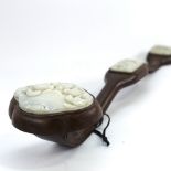 A Chinese hardwood rui sceptre with 3 inset relief carved jade panels, length 50cm, largest jade