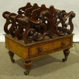 A Victorian walnut Canterbury, carved and pierced acanthus divisions with single drawer below,