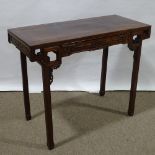 A 19th century Chinese hardwood altar table with relief carved frieze, central frieze drawer