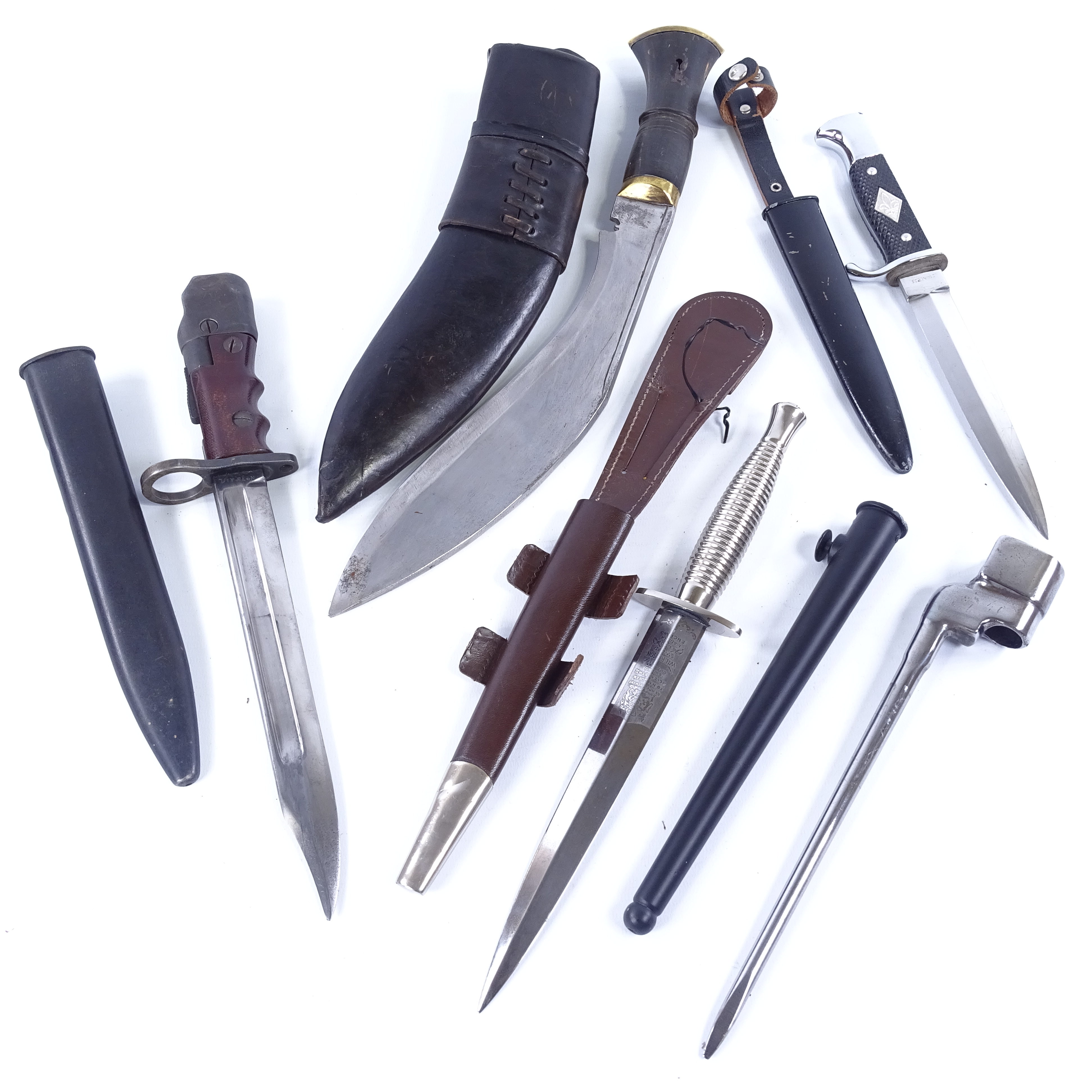 A group of knives and bayonets, comprising a Wilkinson Commando knife with metal scabbard, a No. 7
