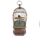 A large Victorian clockwork penny-in-the-slot birdcage automaton, circa 1900, brass wirework cage on