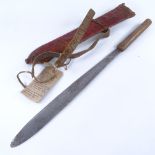 A Kenya Panga (Mau-Mau) dagger with wood handle and leather-covered scabbard, overall length 56cm