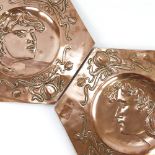 A pair of Art Nouveau copper plaques, relief embossed portrait panels in scroll surrounds, 37cm