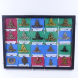 A collection of 21 Royal Artillery cap badges. In good used condition, badges are in box frame