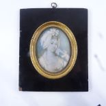 A 19th century miniature watercolour on ivory, head and shoulders portrait of a lady wearing a