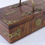 A late 19th century oak cigar and cigarette box, with dual compartments, brass mounts and match