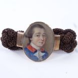 A Georgian woven hair bracelet with central miniature watercolour portrait on ivory, depicting a