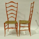 CHIAVARI, ITALY - A pair of exaggerated high ladder back chairs, in sculpted wood in the manner of