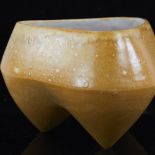 DEANA MOORE, BRITISH, studio ceramic stoneware vessel of tripod form yellow/brown glaze with white