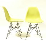 CHARLES EAMES, VITRA, a pair of mustard coloured DSR side chairs, with plastic shell seat on