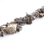 A Vintage sterling silver charm bracelet, infinity links with 23 charms, bracelet length 19cm, 71.1g