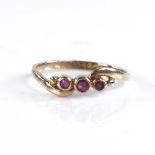 An early 20th century unmarked gold 3-stone ruby crossover ring, setting height 5.1mm, size N, 1.